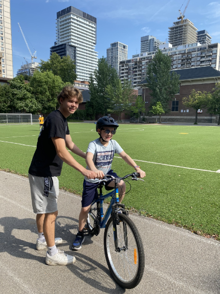 Two kids biking on a field