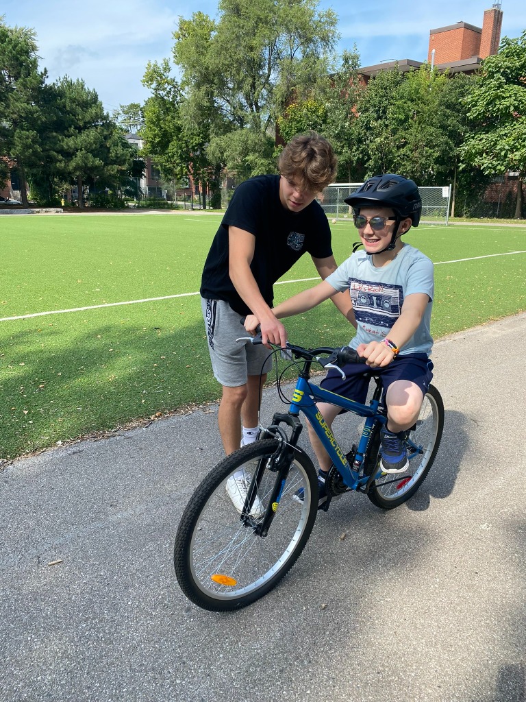 Instructor helping student on bike